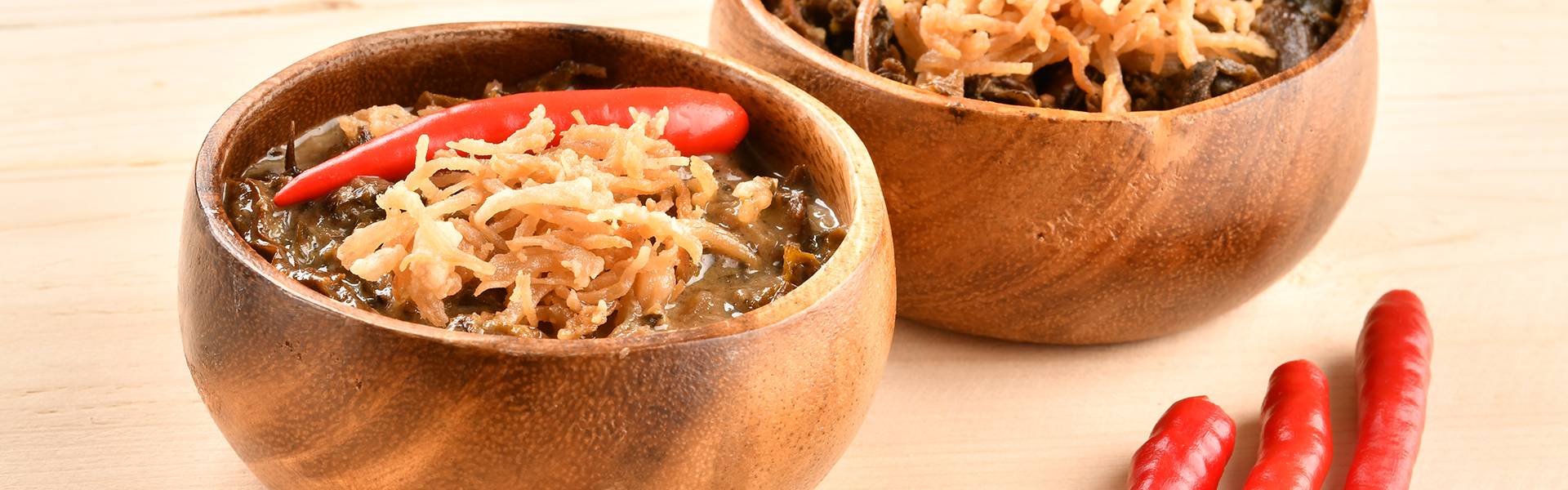 Bowls of laing topped with crispy garnish